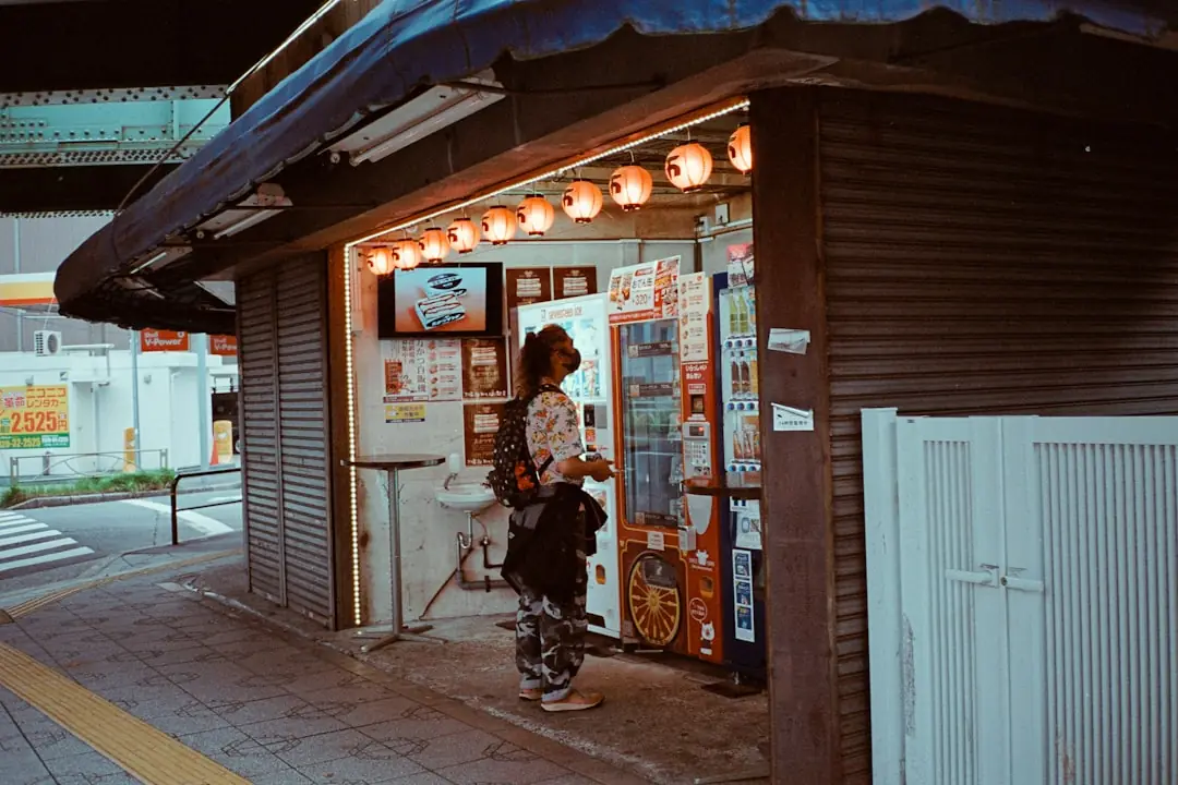 Traveller using a vending machine on a Japanese city street