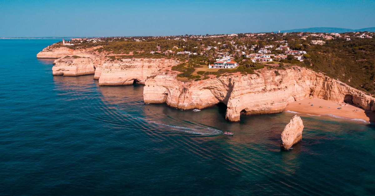 Coastal cliffs and a sandy cove in the Algarve