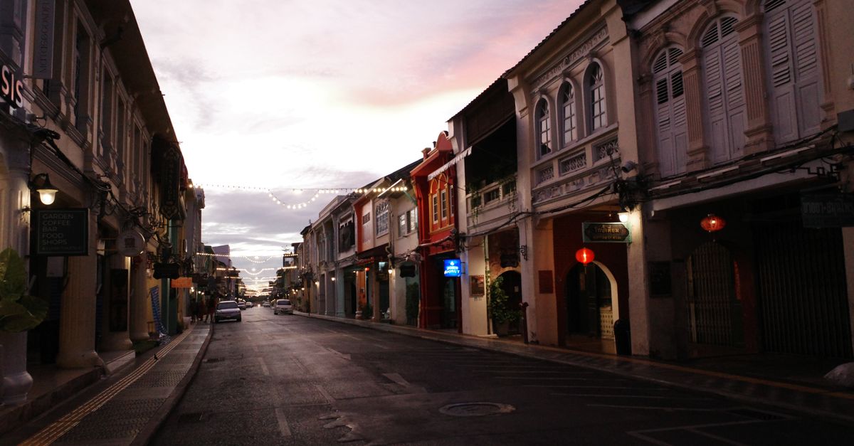 Historic shophouses on a Phuket Town street at dusk