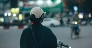 Helmeted scooter rider on a busy city street