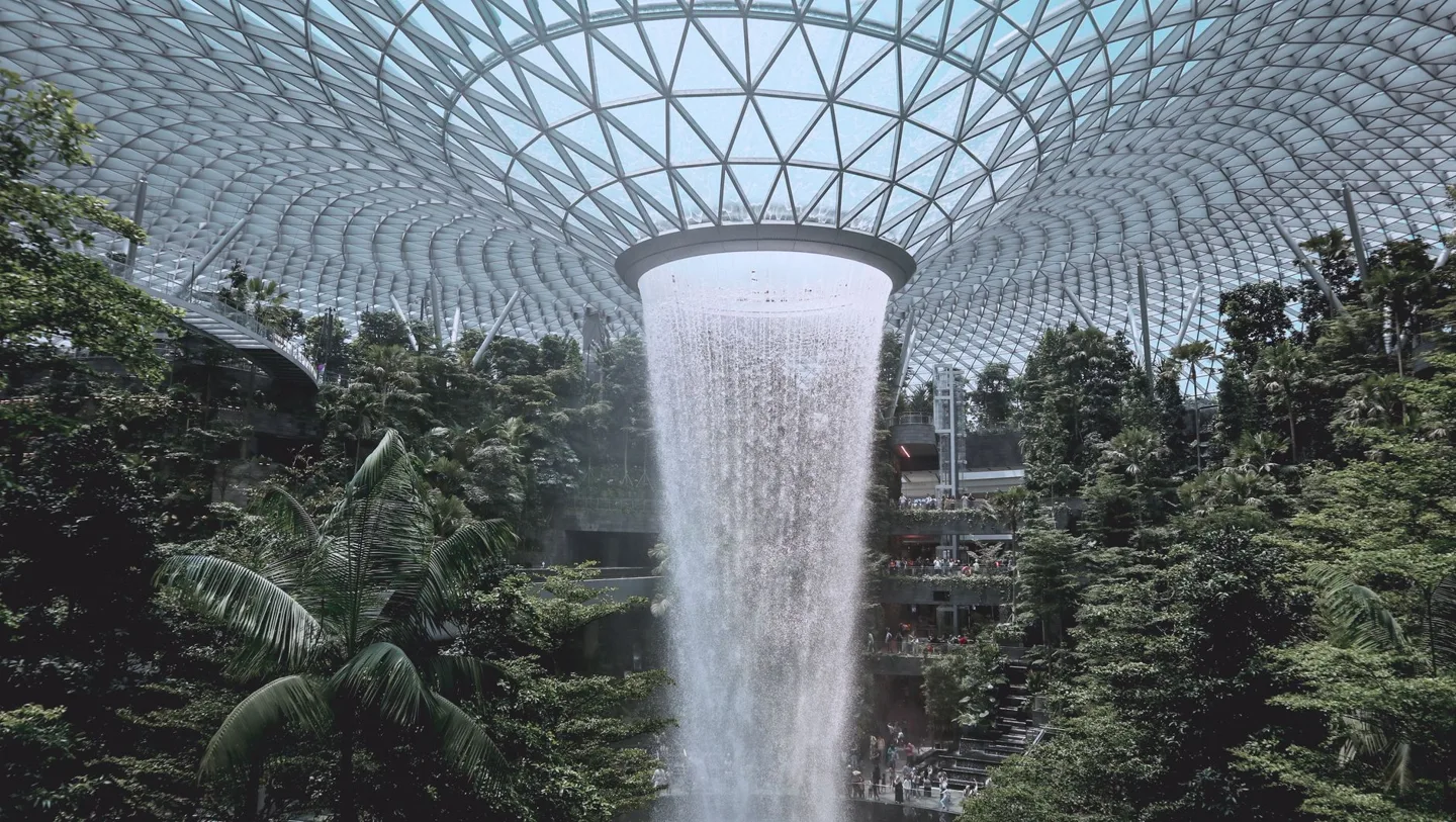 Rain Vortex waterfall and indoor gardens beneath Jewel Changi’s glass roof